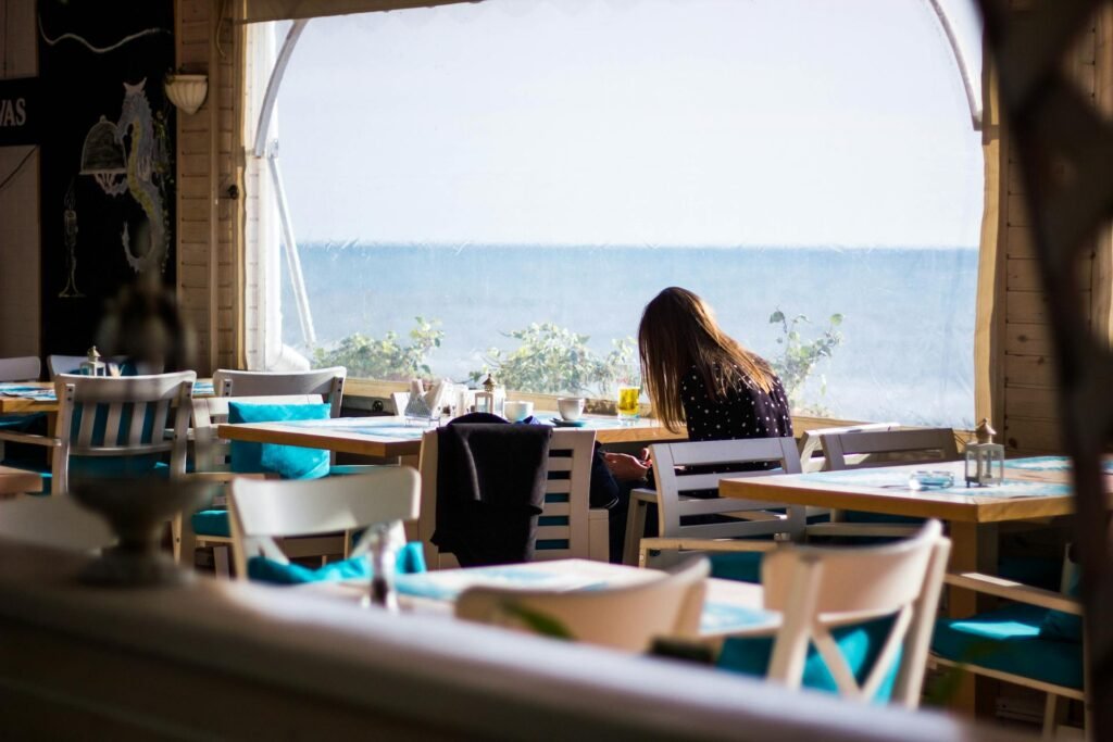 girl sitting at a summer restautant